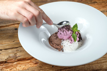 Male hand with a spoon of ice cream