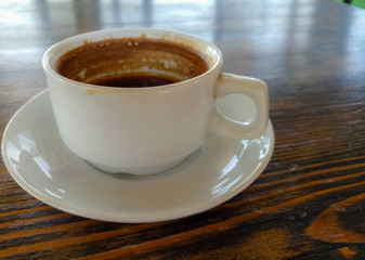 a Cup of natural black coffee on a wooden table in a seaside cafe
