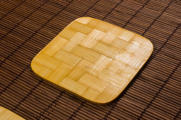 bamboo Mat - stand food with bamboo stands for hot, close-up, wooden background