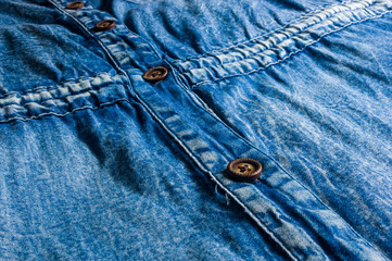 Blue washed faded jeans texture with seams, clasps, buttons and rivets