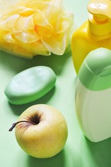 Top view photo bath products. Organic shampoo, liquid soap packaging, sponge and apple