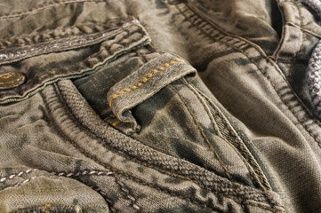 clothing items washed cotton fabric texture with seams, clasps, buttons and rivets