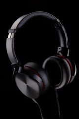 Fototapeta na wymiar computer accessory headphones black on a black background advertising shot