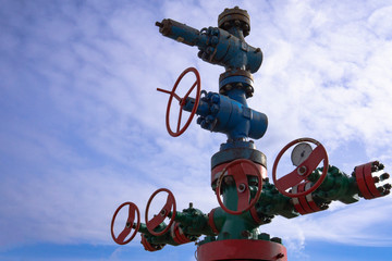 Oil and gas processing plant with pipe line valves. Oil pipeline valves in the oil and gas industry. Valve plug an oil pipeline in the field on a sunny summer day