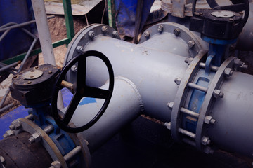 Oil and gas processing plant with pipe line valves. Oil pipeline valves in the oil and gas industry. Valve plug an oil pipeline in the field on a sunny summer day