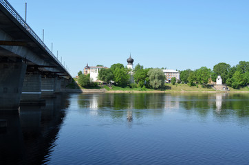 Fototapeta na wymiar Russia. Pskov. The Great river, to the left ol the bridge across the river the dome of the Dormition Church, on the right Olginskaya chapel