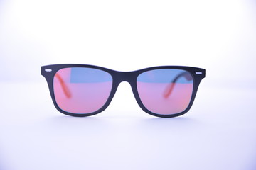 Black-rimmed sunglasses with rainbow glasses on a white background isolated