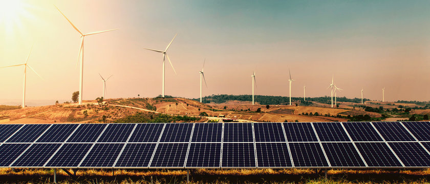wind turbine with solar panel on hill and sunshine background. concept clean energy power in nature