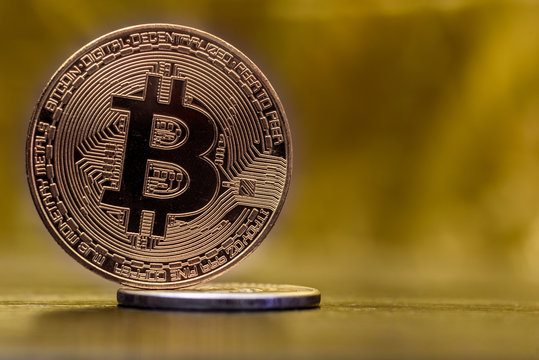 Bitcoin closeup on a golden background.