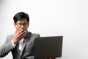 A business man with shock expression on face while looking at the laptop computer screen. happily shock. 