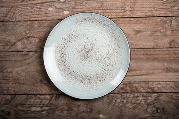Empty dish on wood background. Top view.