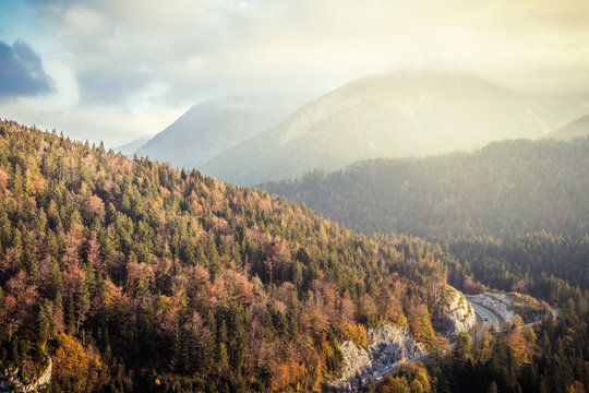 Curvy road in the European Alps in Austria in autumn colors, nature background concept
