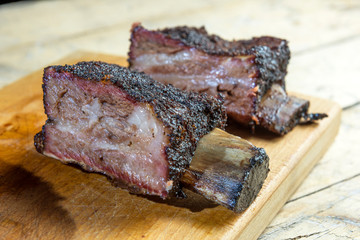 Smoked beef ribs cut on chopping board