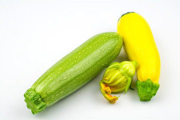 Two zucchini yellow and green color and a flower isolated on a white background.
