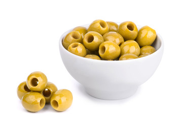 Green group of olives in a white ceramic bowl isolated on white background.