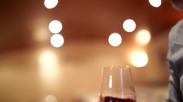 Slow motion close up of winemaker tasting red wine