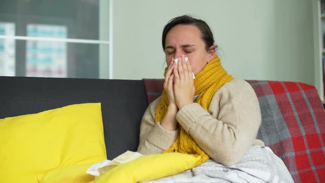 Young Woman with Flu Using a Handkerchief at Home