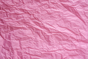 Abstract texture of pink crumpled paper background. Wrinkled soft packaging paper. Recycled paper.