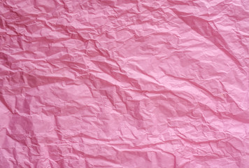 Fototapeta premium Abstract texture of pink crumpled paper background. Wrinkled soft packaging paper. Recycled paper.