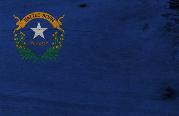 Flag of Nevada on wooden plate background. Grunge Nevada flag texture, The states of America. Solid...