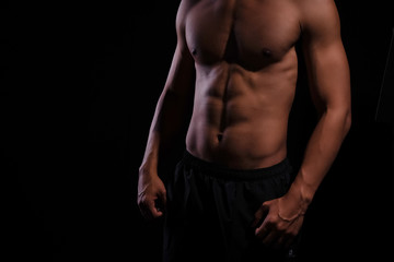 Fototapeta na wymiar The human with muscular torso on black background,show fit and firm body,strong muscle