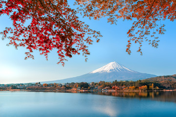 Mount fuji at Lake kawaguchiko with sunrise in the morning and Autumn colorful red maple leaf.