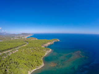 Fototapeta na wymiar aerial view on beach and coast of sea, turquoise water, top view. Phaselis beach in Antalya, Turkey 