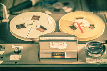 Classic reel audio recorder with a few rolls of tape