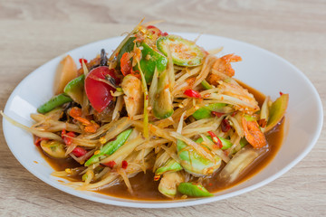 papaya salad, black crab and pickled fish in white dish, delicious thailand food