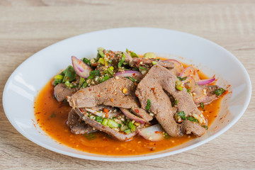 Pork liver spicy salad in white dish, delicious thai food