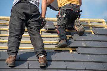 two carpenters working on roof