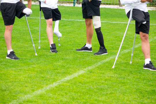 close-up of ampute soccer player and team friends