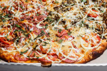 Pizza in a cardboard box. Close up. Pizza delivery. Pizza menu