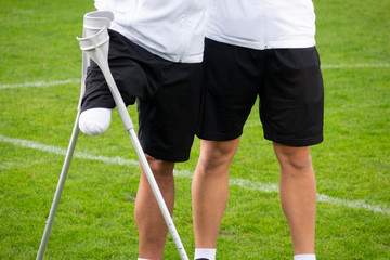 close-up of ampute soccer player and team friend