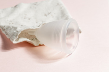 Fototapeta na wymiar Menstrual cup on pink background, feminine hygiene