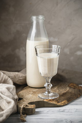 Fresh milk in glass bottle on rustic background