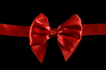 Red satin ribbon and bow isolated on black background