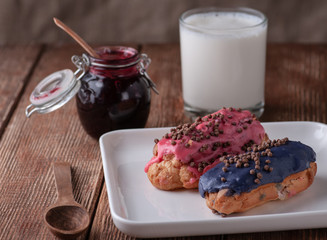 Powdered casserole with pink and pigeon is served with jam and milk. wooden base table