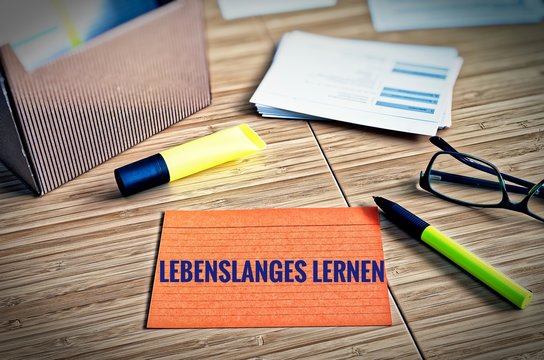 Index cards with legal issues with glasses, pen and bamboo with the german words Lebenslanges Lernen in english lifelong learning