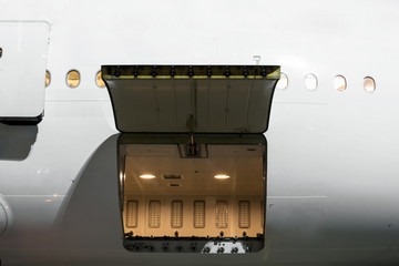 Cargo section in the airplane open on inspection, with bags and luggage of passengers. - obrazy, fototapety, plakaty