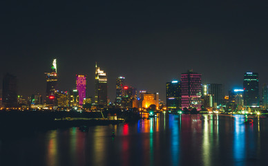 Fototapeta premium Buildings along Saigon river (Vietnam) in sunset