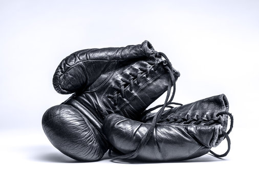 Old boxing gloves on a white background