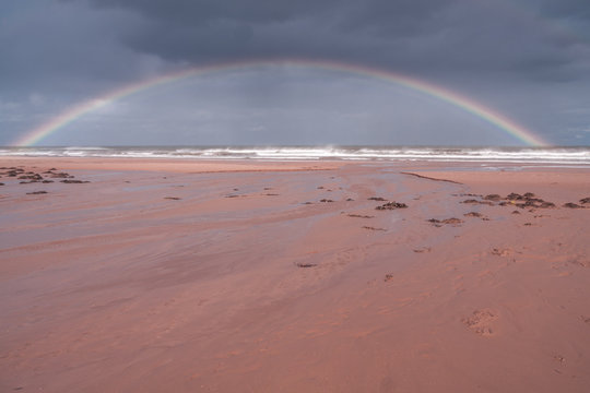 rainbow over prince Edward island beach after autumn storm