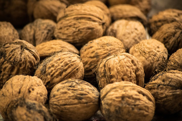 Closeup of a pile of walnuts. Scattered pile of walnuts. Background. Fresh walnuts