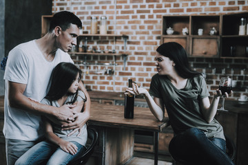 Father and Child Look at Drunk Mother in Kitchen