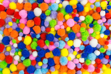 Fototapeta na wymiar background of brightly colored pom-poms