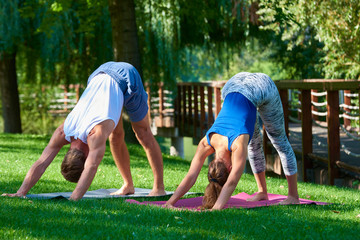 Couple doing yoga exercises together outdoor