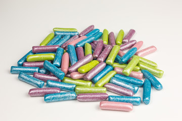 heap of gummy candy in mermaid colors dusted with silver