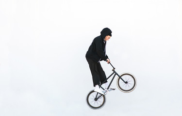 Bmx rider jumping with a bicycle on a white background. Rider jump on bmx isolated on white background.Copyspace. Bmx concept