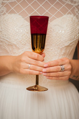 a glass of champagne in the hand of the bride